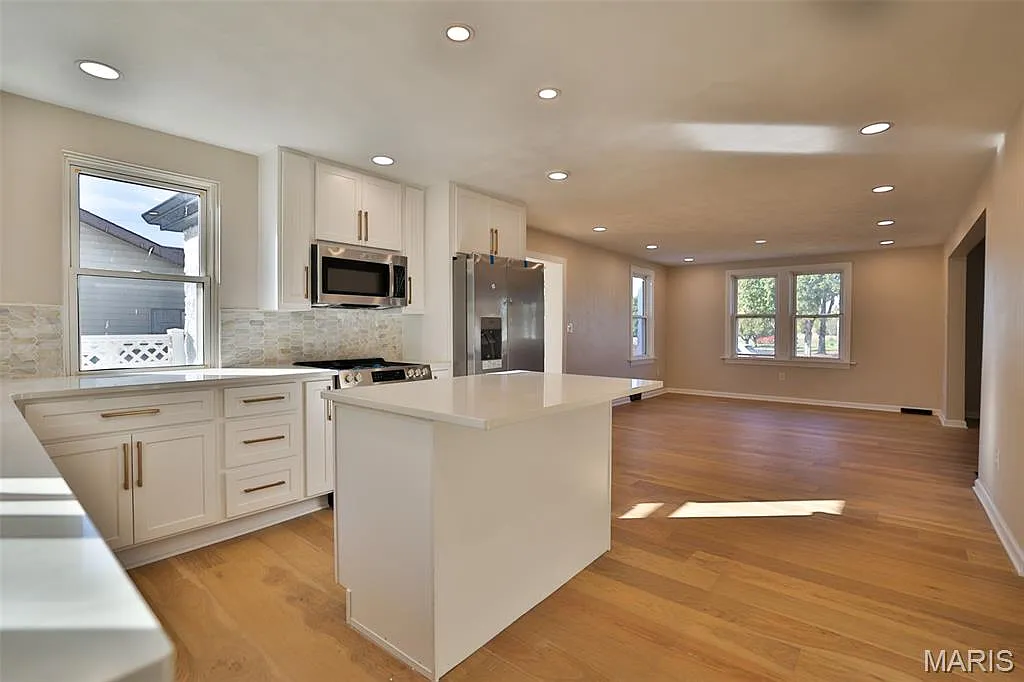 Renovated open kitchen after Simply Sold buys distressed home